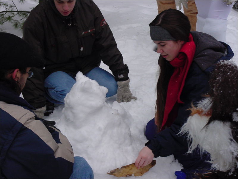 [WindGrowler_SF2002_11 Nala sculpting a snow racoon.JPG]
